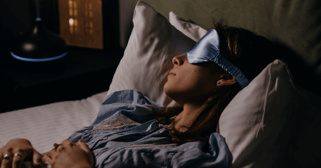white women sleeping with light blue silk eye shield