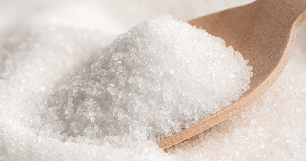 sugar pile with a wood spoon underneath