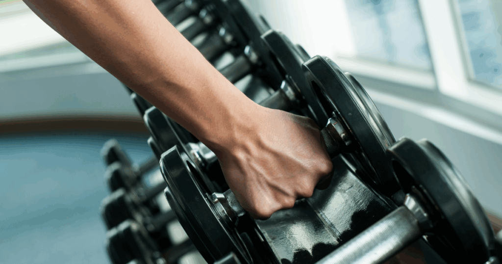 Woman lifting weights at home or gym