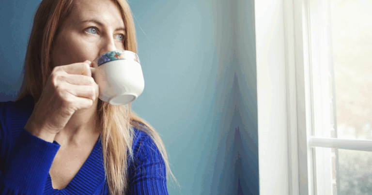 Woman sipping tea by a window