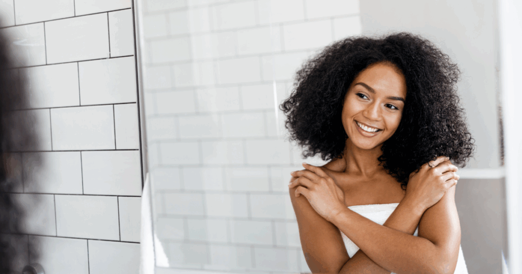Woman smiling in front of a mirror